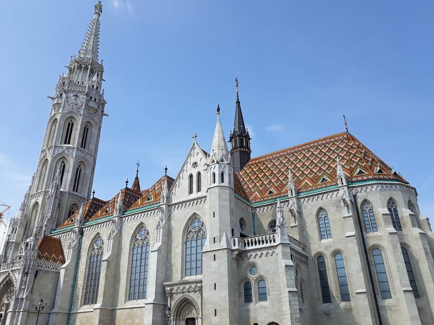 Budapest: Buda Castle Walking Tour & Folk Music Performance - Matthias Church and the first layer of Castle Hill